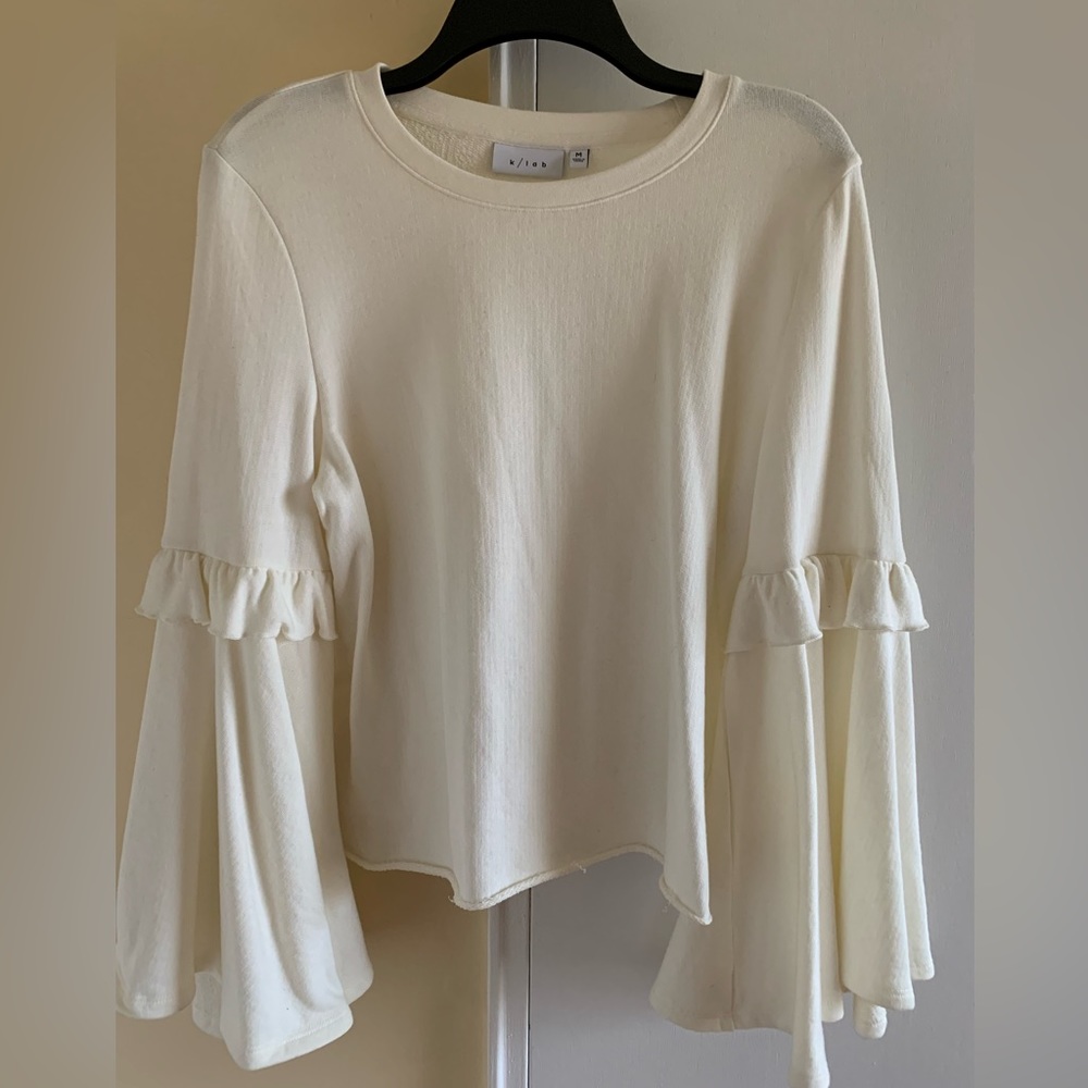 Women’s top with bell sleeves.